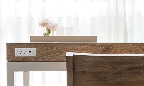 wooden desk beside white ruffle curtain